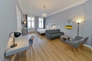 main living room and bedroom in family plus apartment at OTA-Berlin